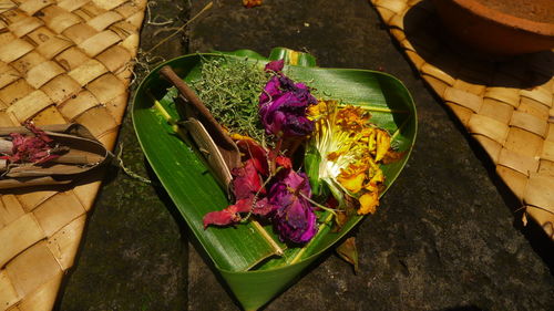 Flowers arranged in wicker tray as religious offerings