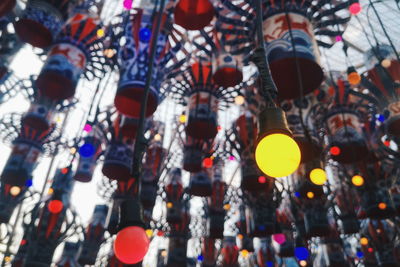 Low angle view of lights hanging on ceiling at market