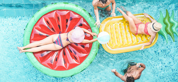 High angle view of people with inflatable rafts in swimming pool