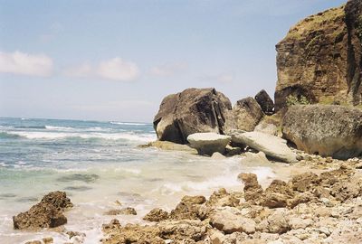 Rocks on beach against sky