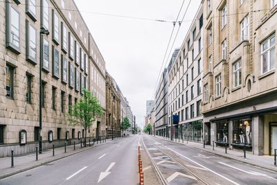 Empty road with buildings in background