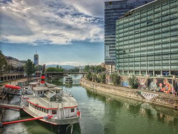 Boats in river with buildings in background