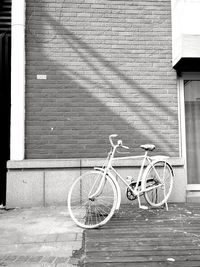 Bicycle against building in city