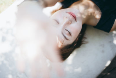 Close-up portrait of woman lying down