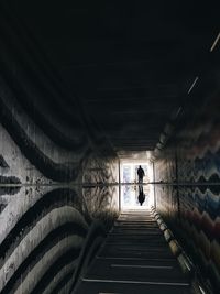 Silhouette people in tunnel