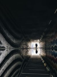 Silhouette people in tunnel