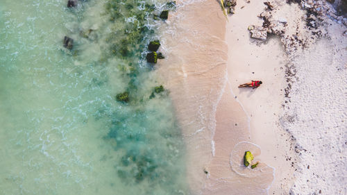 Aerial view of woman lying at beach