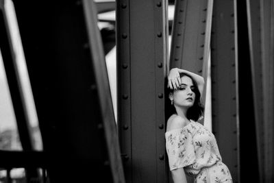 Portrait of woman standing against wall