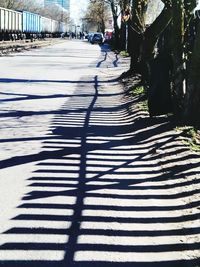 Shadow of person walking on footpath