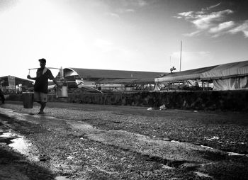 Full length of woman standing against sky