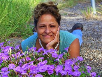 Portrait of a young woman holding purple flowers