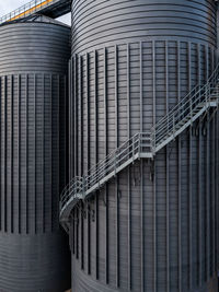 Close up of industrial storage tank silo with external step ladders for access with copy space