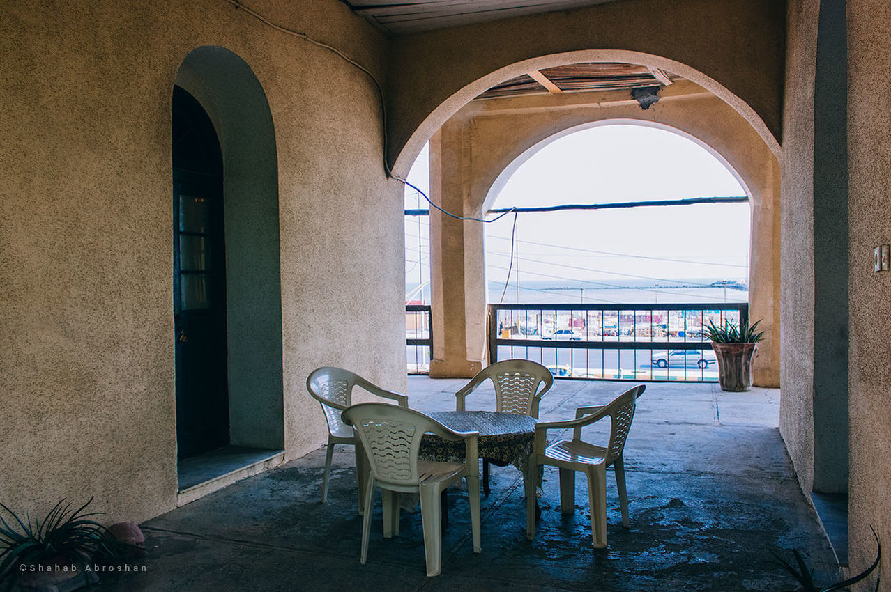 arch, seat, chair, architecture, table, built structure, indoors, no people, window, building, furniture, day, absence, empty, flooring, nature, entrance, door, architectural column, setting