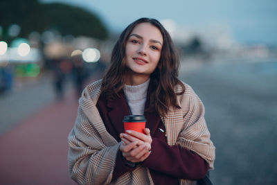 Portrait of a beautiful young woman drinking water