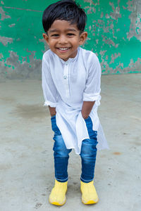 Portrait of a smiling boy standing outdoors