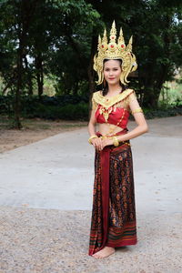 Portrait of woman wearing traditional clothing on footpath