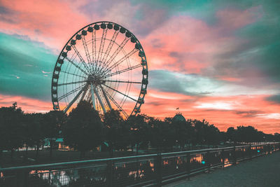 Ferris wheel against sky during sunset