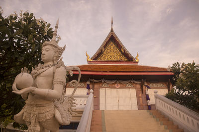Statue of temple against building