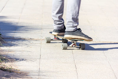 Teen legs in jean on skateboard