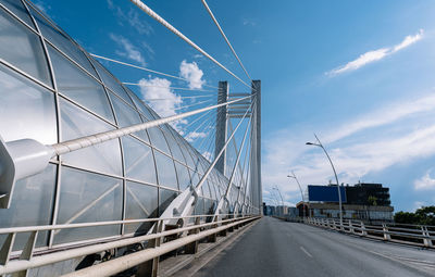 White cable bridge and road in the city