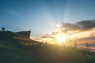 Scenic view of land against sky during sunset