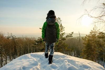 А severe hiker walking along the mountain path route. the urals landsc