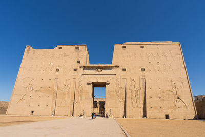 Low angle view of historical building against clear blue sky