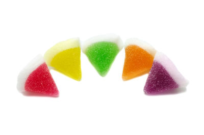 Close-up of multi colored candies against white background