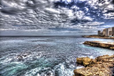 Scenic view of sea against cloudy sky