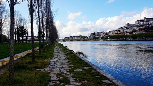 Scenic view of river amidst buildings against sky