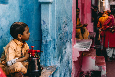 Side view of a boy looking at camera