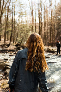 Rear view of woman standing on snow covered land