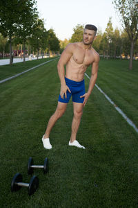 Full length of young man sitting on grass