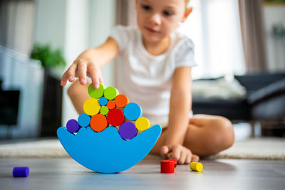 Midsection of girl playing with toy blocks