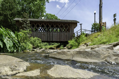 Stone bridge over river against sky