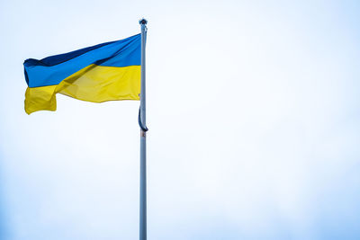 Flag of ukraine on white sky background. national symbol of freedom and independence.