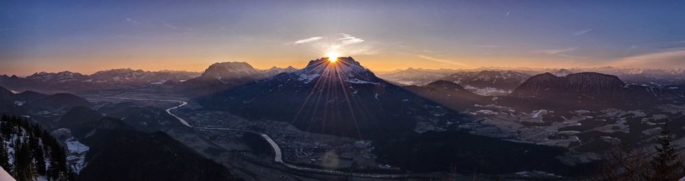 Scenic view of snowcapped mountains against sky during sunset