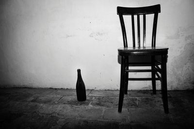 Chair and bottle on floor