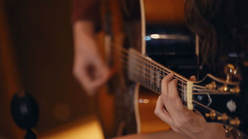 Close-up of man playing guitar