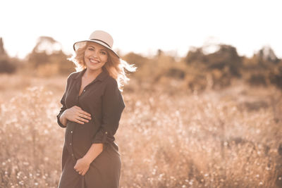 Pregnant woman standing in field