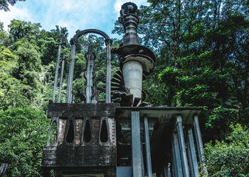 Low angle view of built structure against trees