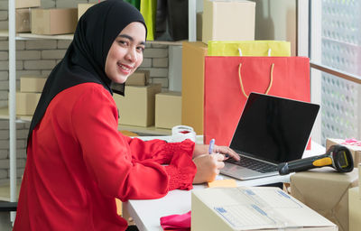 Side view of a woman using mobile phone