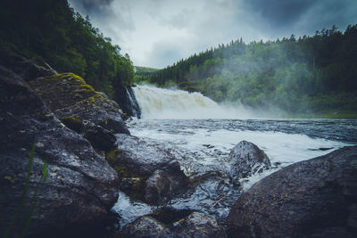 Scenic view of river flowing through landscape