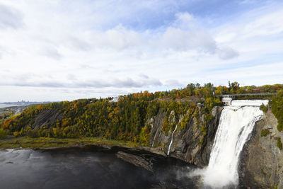 Scenic view of waterfall against sky