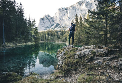 Full length of man standing on rock in forest