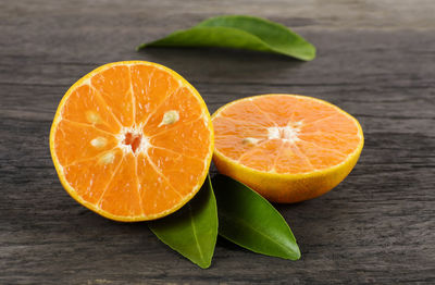 Fresh orange cut in half on a wooden table