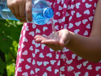 Close-up of hand holding red water