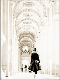 Rear view of woman walking in temple