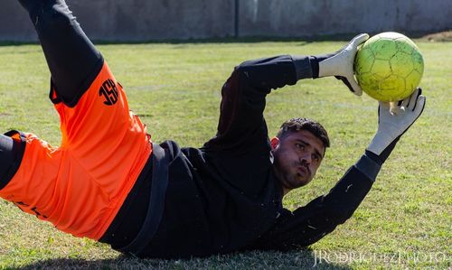 Portrait of man playing soccer on field