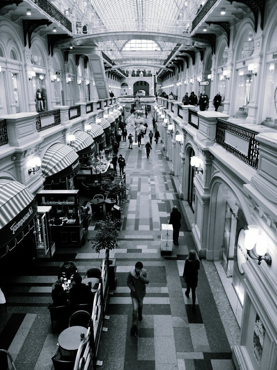 large group of people, indoors, person, public transportation, men, railroad station, architecture, transportation, built structure, walking, city life, lifestyles, travel, incidental people, rail transportation, ceiling, railroad station platform, shopping mall, shopping